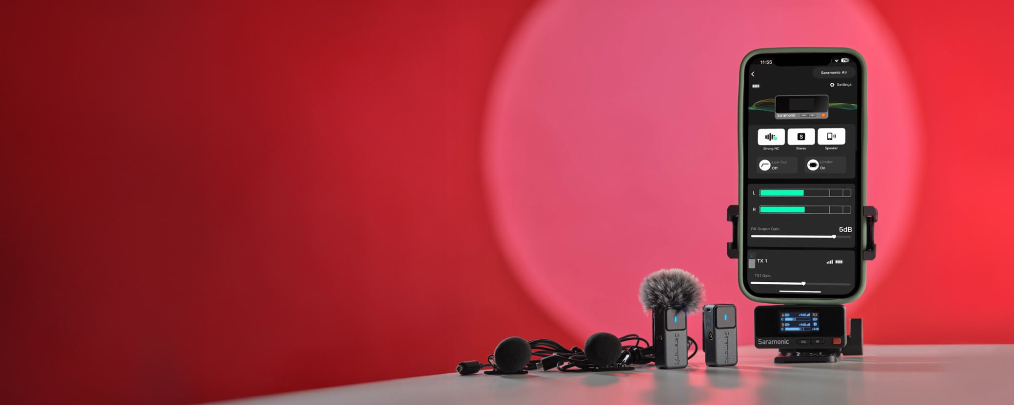 Smartphone with audio app on screen beside earphones and microphone, against a red background