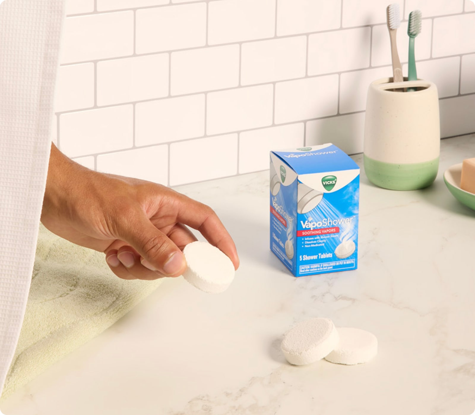 Hand grabbing an egg from a carton on a kitchen counter