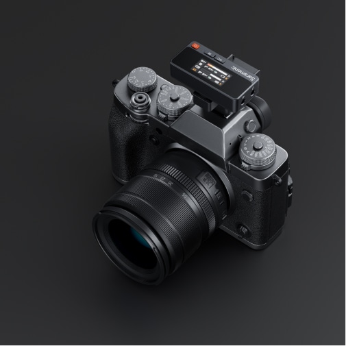 Digital mirrorless camera with lens on a dark background