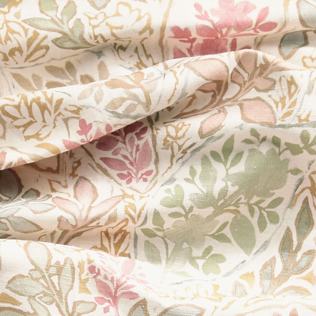 Close-up of a floral fabric with pink, green, and beige tones