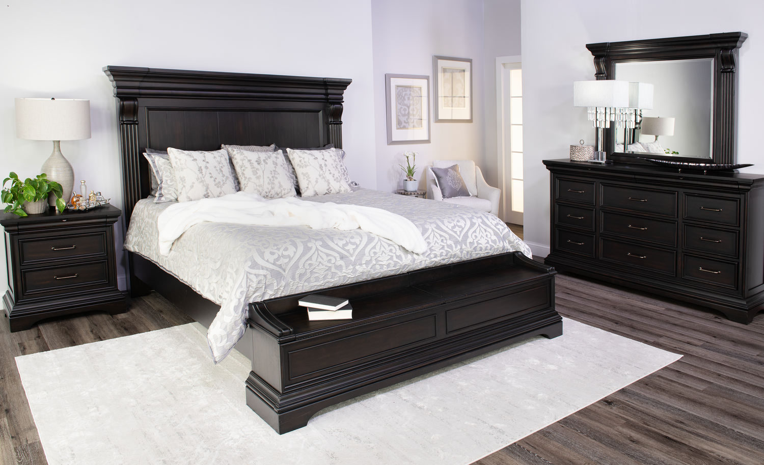 Elegant bedroom with black furniture set including bed, nightstands, and dresser