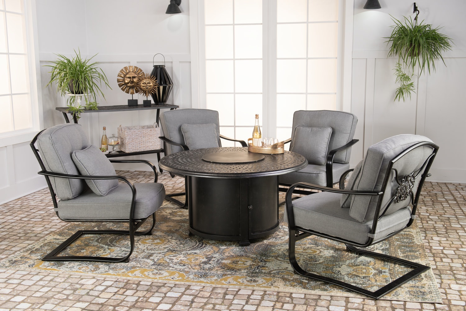 Modern dining room with round table, four chairs, and decorative plants