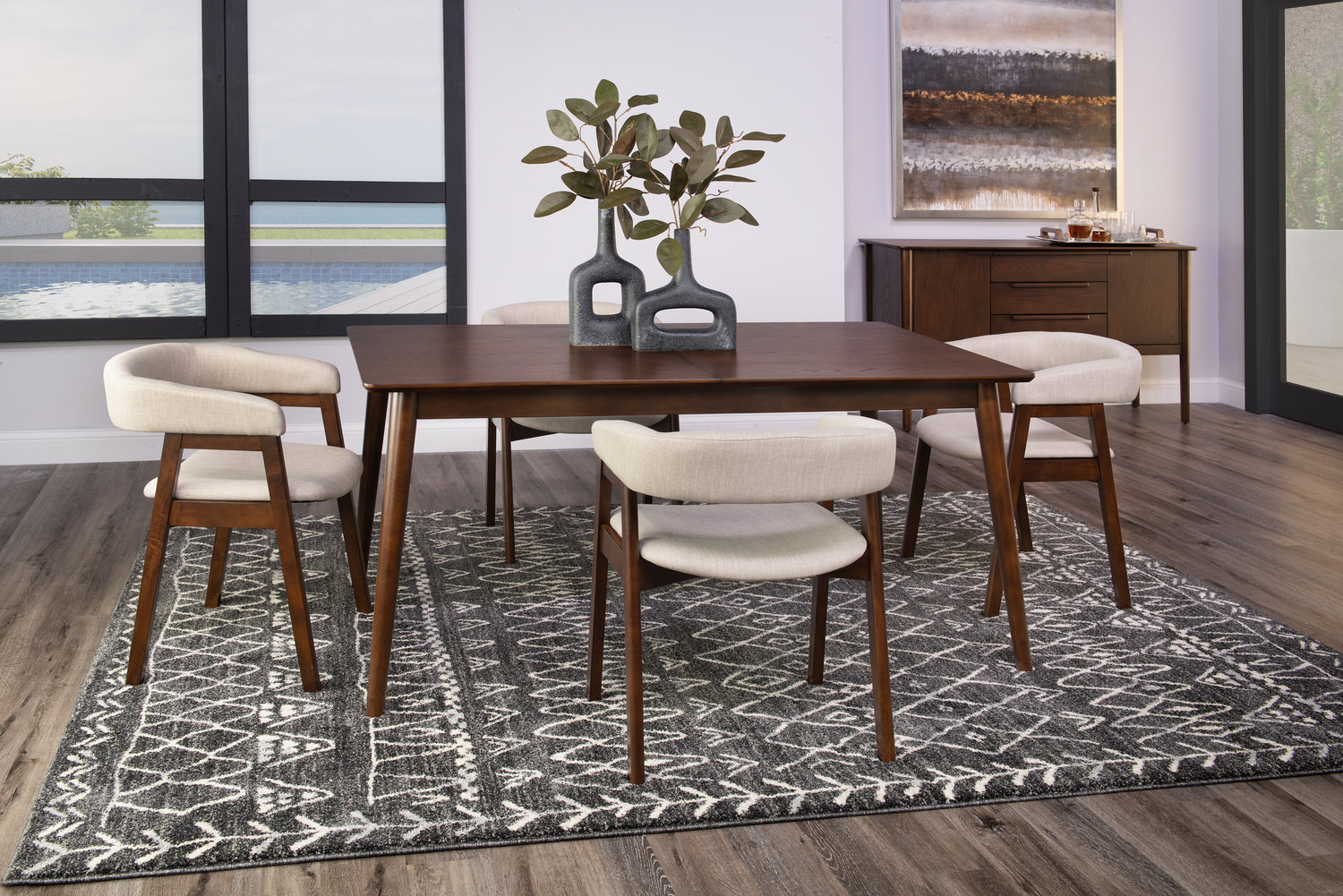 Modern dining room with a wooden table, four chairs, area rug, and a sideboard against large windows