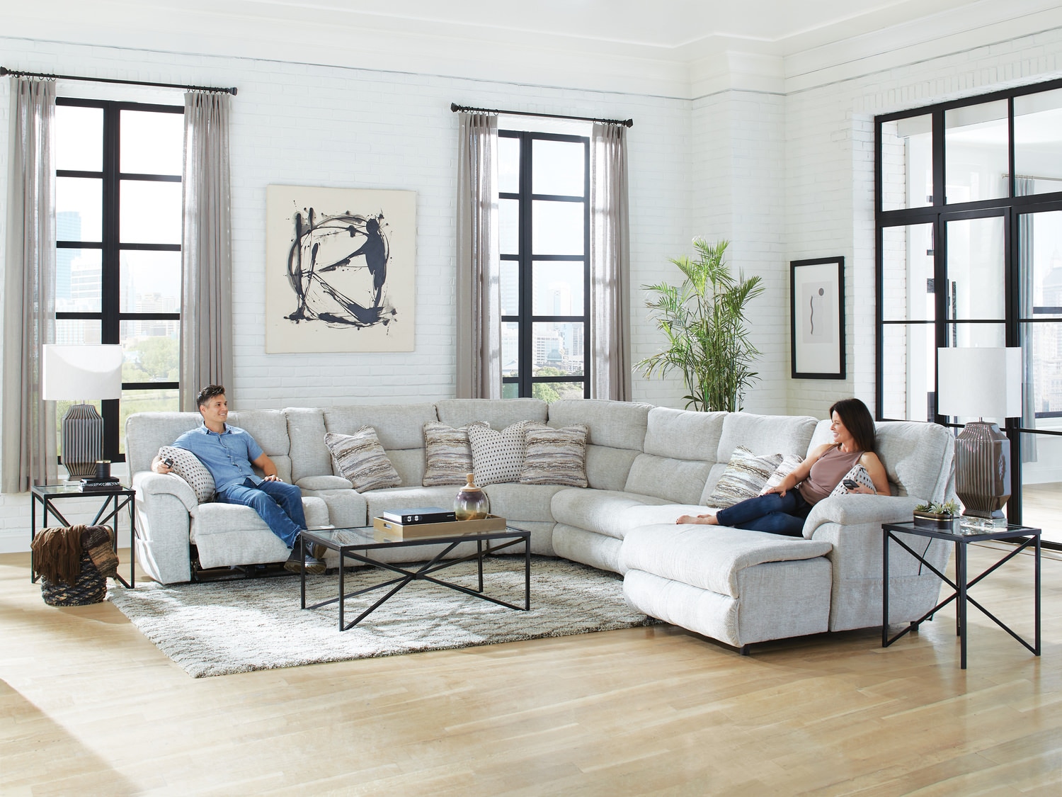 Two people relaxing in a spacious living room with modern furniture