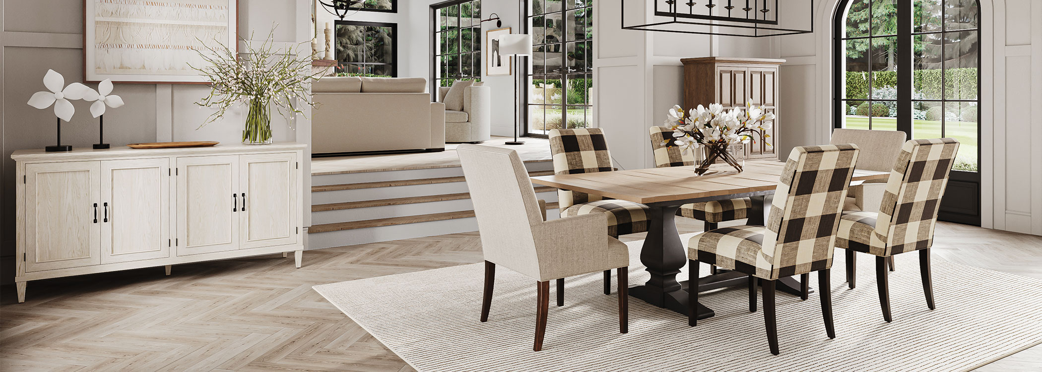 Modern dining room with a long table, patterned chairs, and a sideboard, overlooking windows