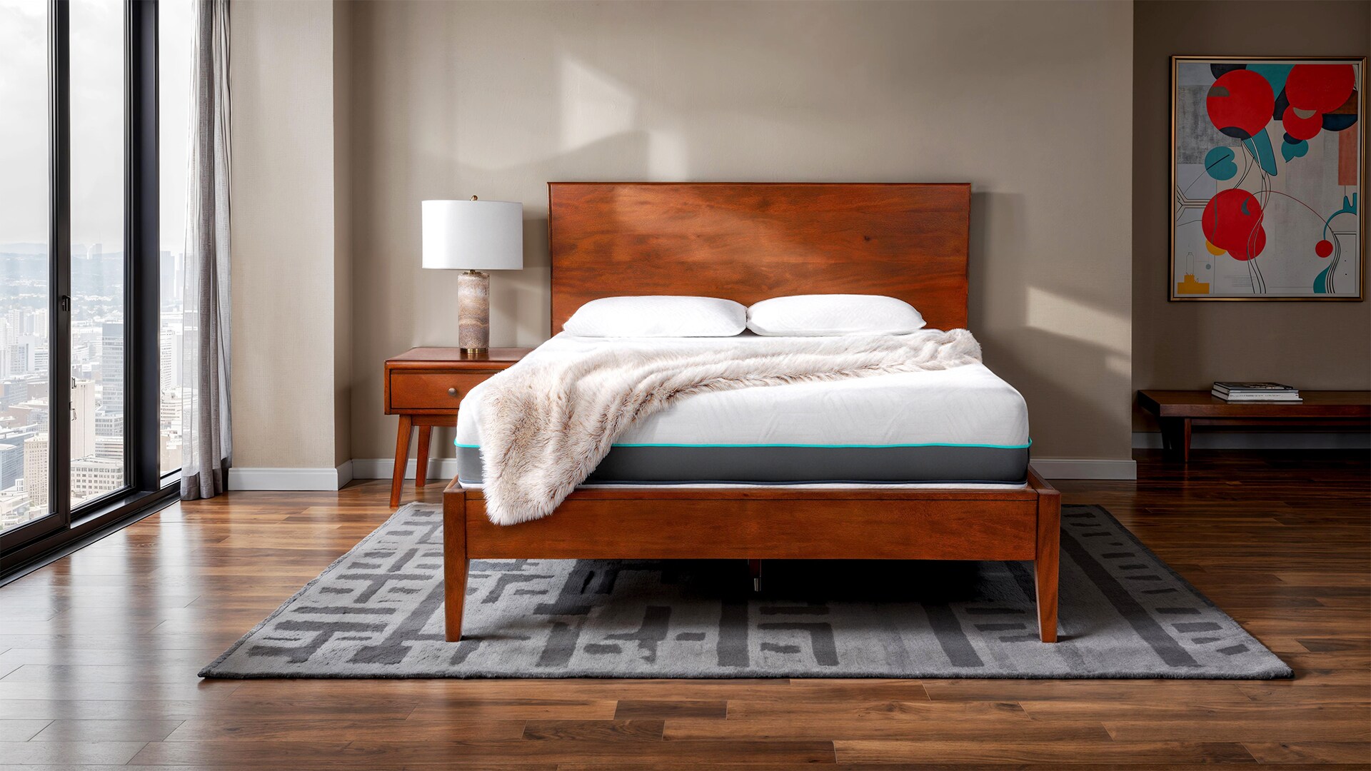 Modern bedroom with wooden bed, white bedding, and colorful wall art