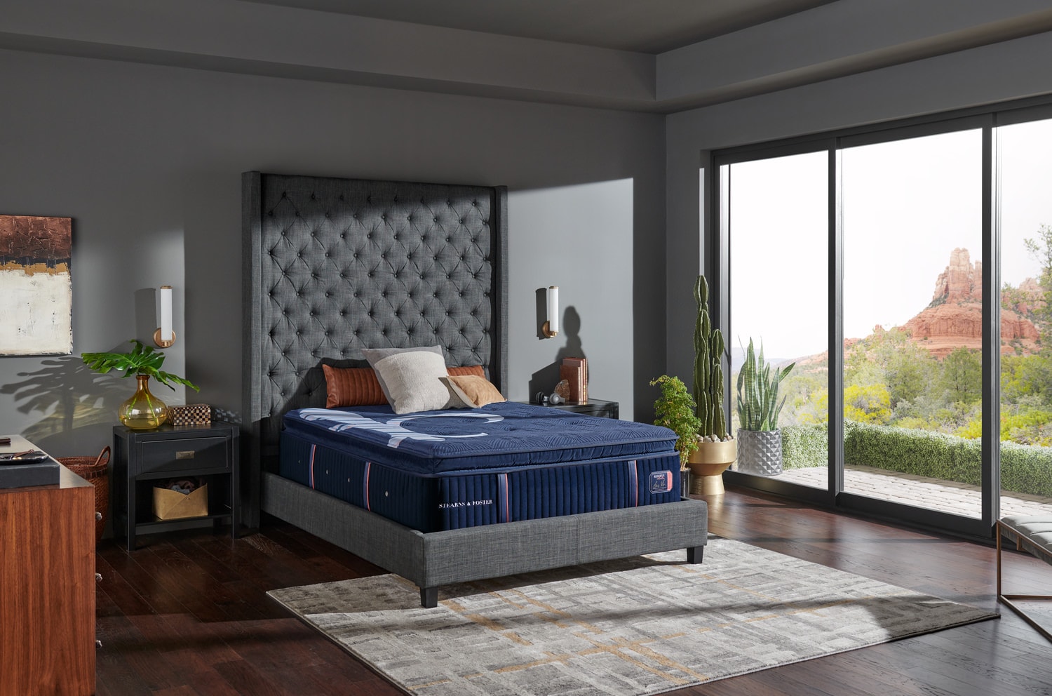Modern bedroom with large bed, floor-to-ceiling windows, and a scenic view