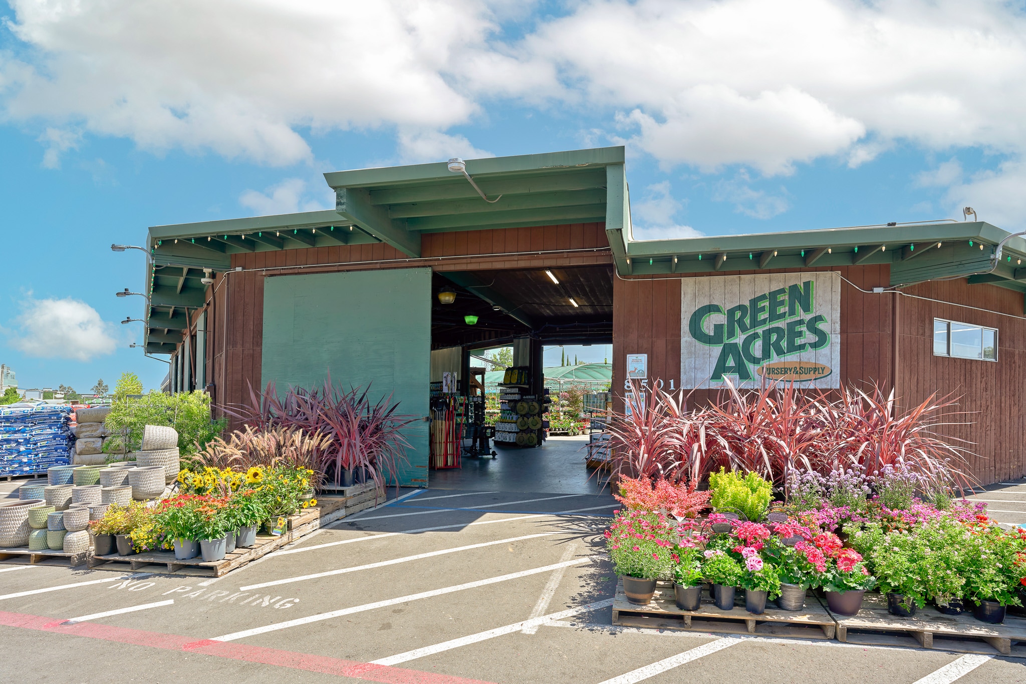 Entrance of Green Acres Nursery with colorful plants on display