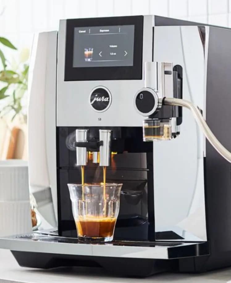 Espresso machine dispensing coffee into a glass cup