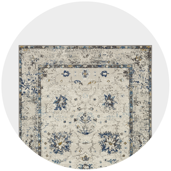 A vintage ornate rug featuring blue and beige patterns