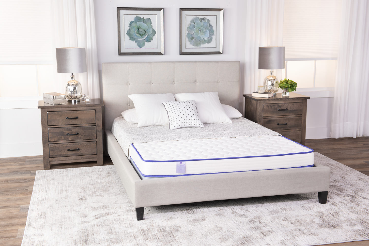 Modern bedroom with a neatly made bed, two nightstands, and decorative wall art