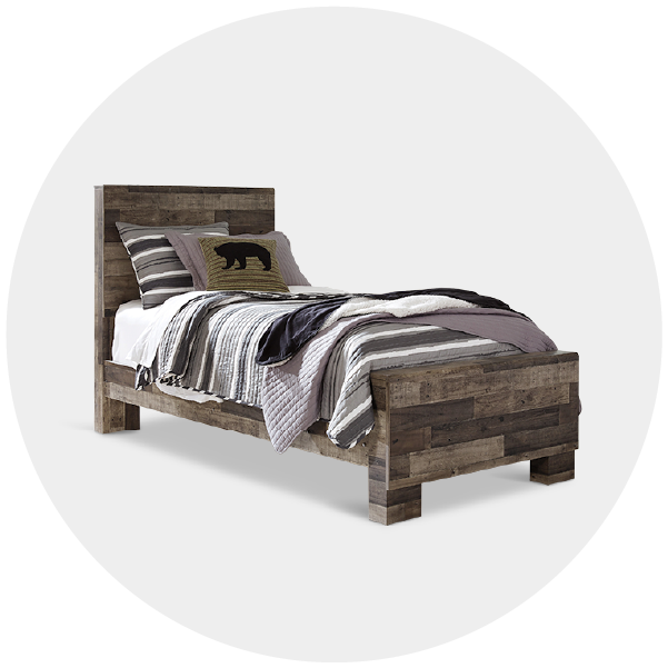 Single rustic wooden bed with striped bedding and a bear-shaped pillow