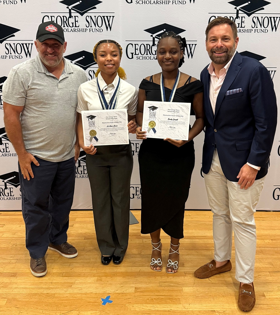 Four adults standing with awards at the George Snow Scholarship Fund event