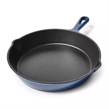 Blue-handled cast iron skillet on a white background