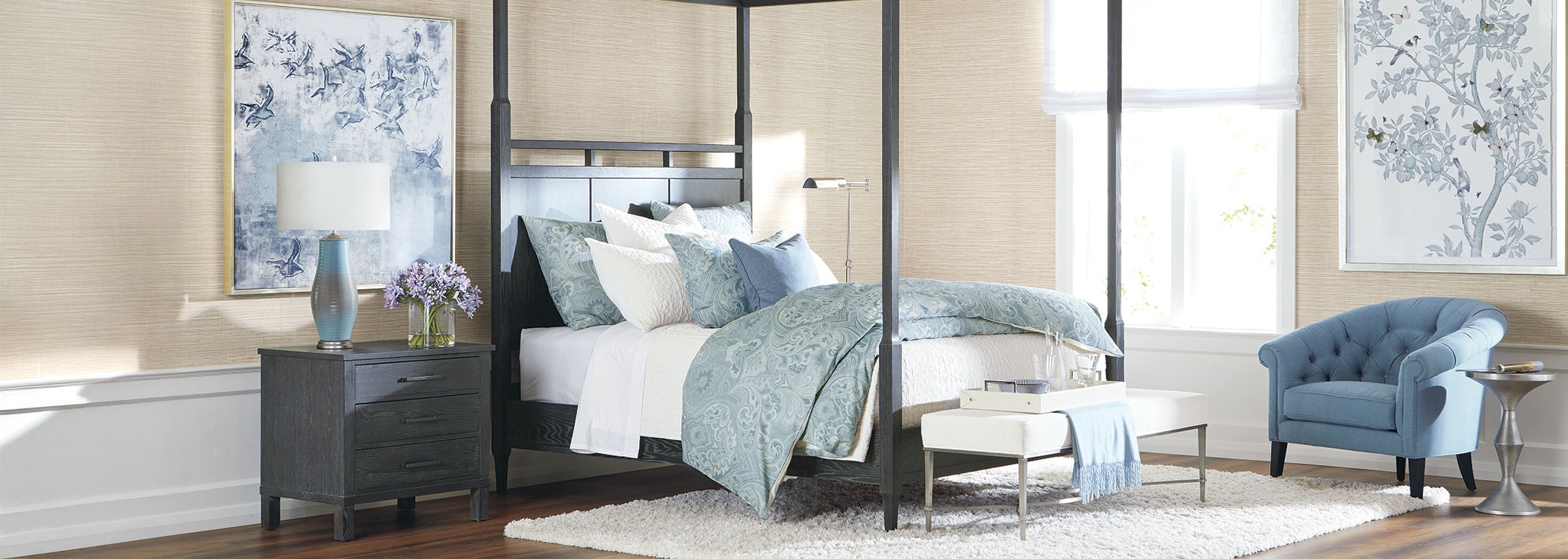 Elegant bedroom interior with a canopy bed, blue accents, and large windows