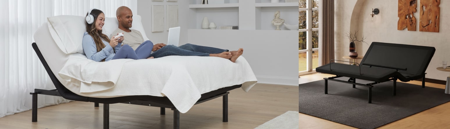 Couple relaxing on a lounge bed in a modern apartment, using a laptop
