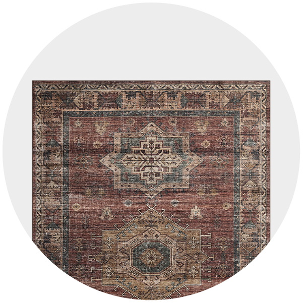 Circular cropped image of an ornate, distressed vintage rug with intricate patterns and a central medallion