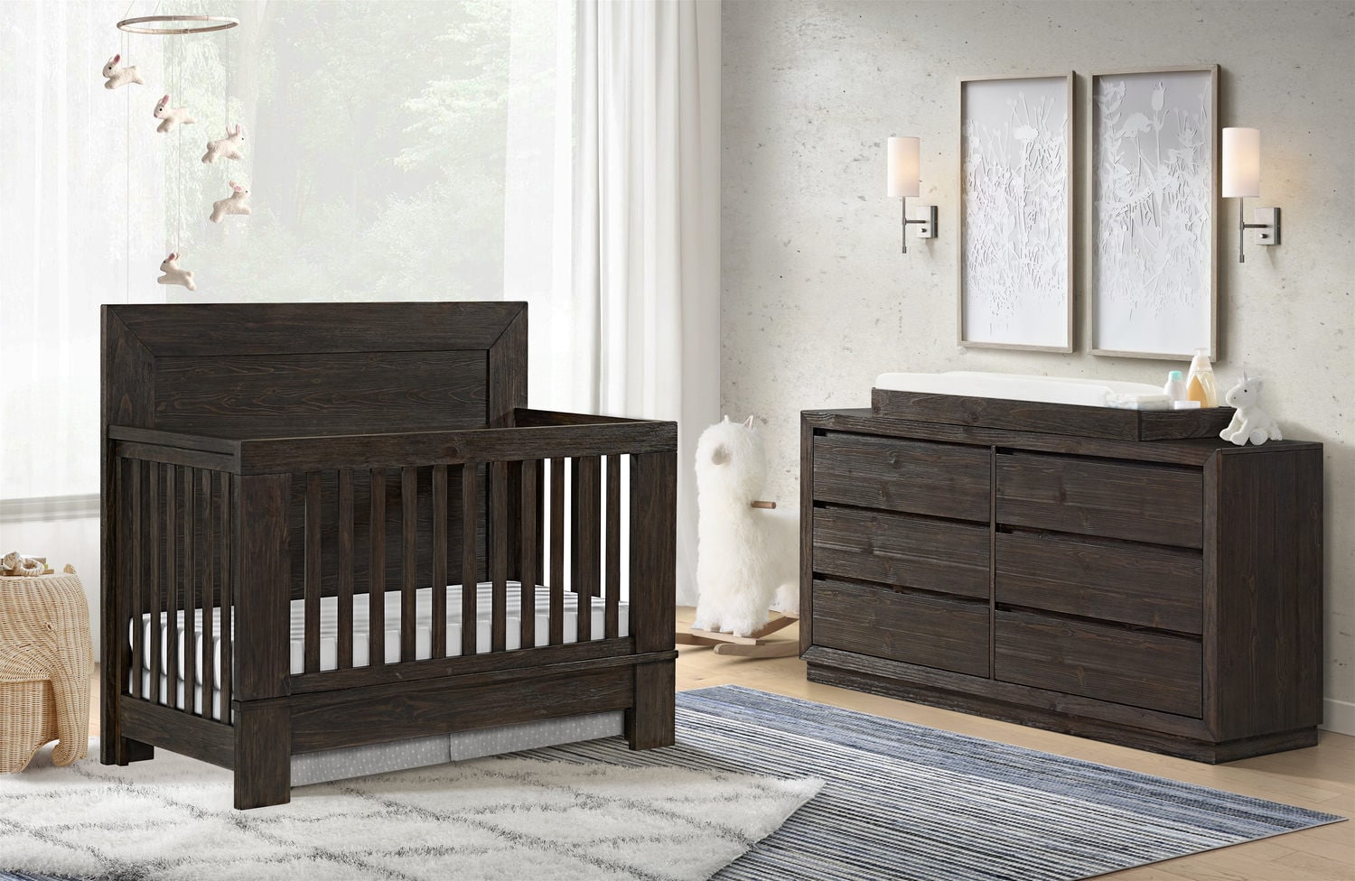 Modern nursery with dark wood crib and dresser in a stylish room