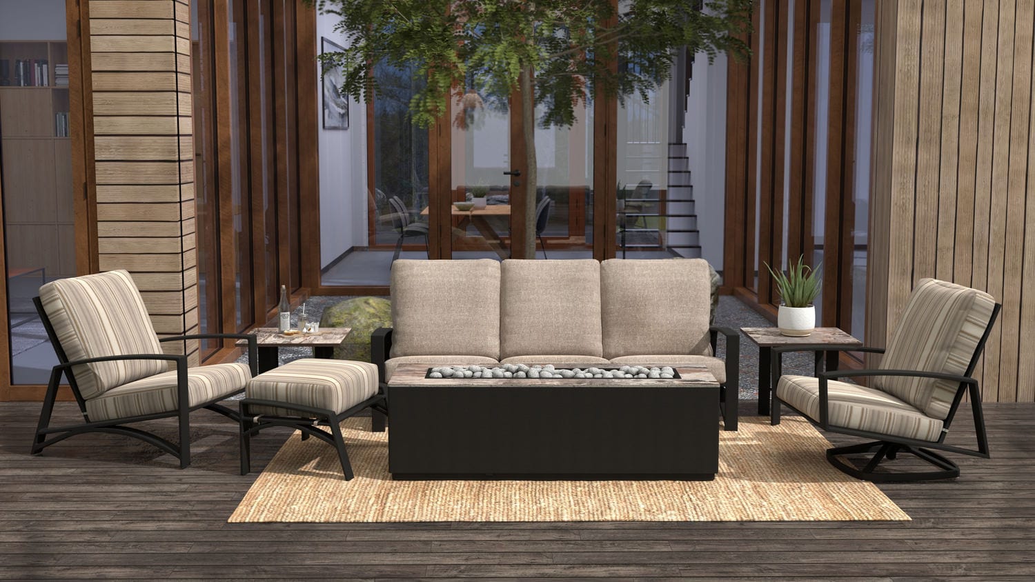 Outdoor patio furniture set on a wooden deck surrounded by trees