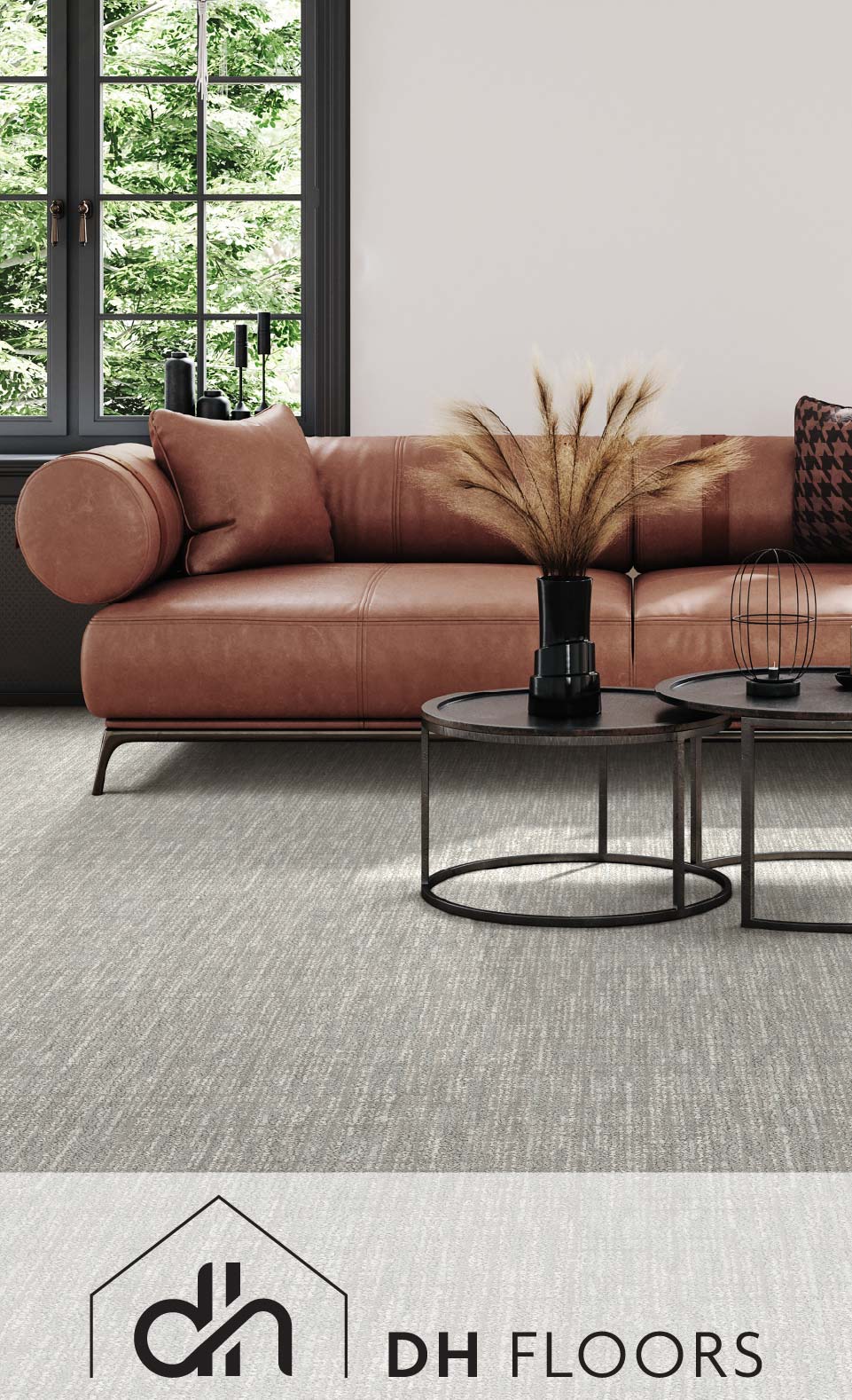 Modern living room with a brown sofa, round glass table, and gray carpet, overlooking a garden through large windows