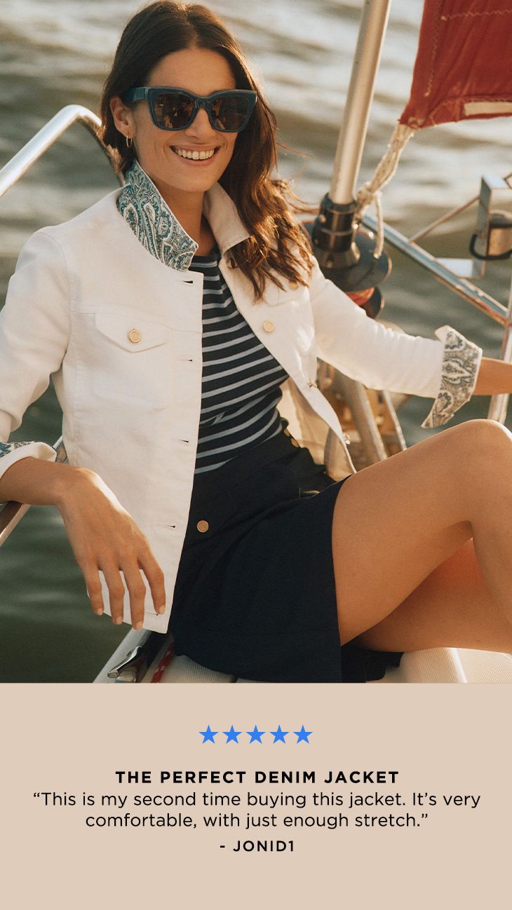 Woman in sunglasses and denim jacket sitting on a sailboat, with a review text overlay about the jacket