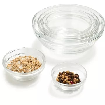 Duralex glass bowls containing salt, pepper, and mixed spices, suitable for cooking or seasoning in a kitchen