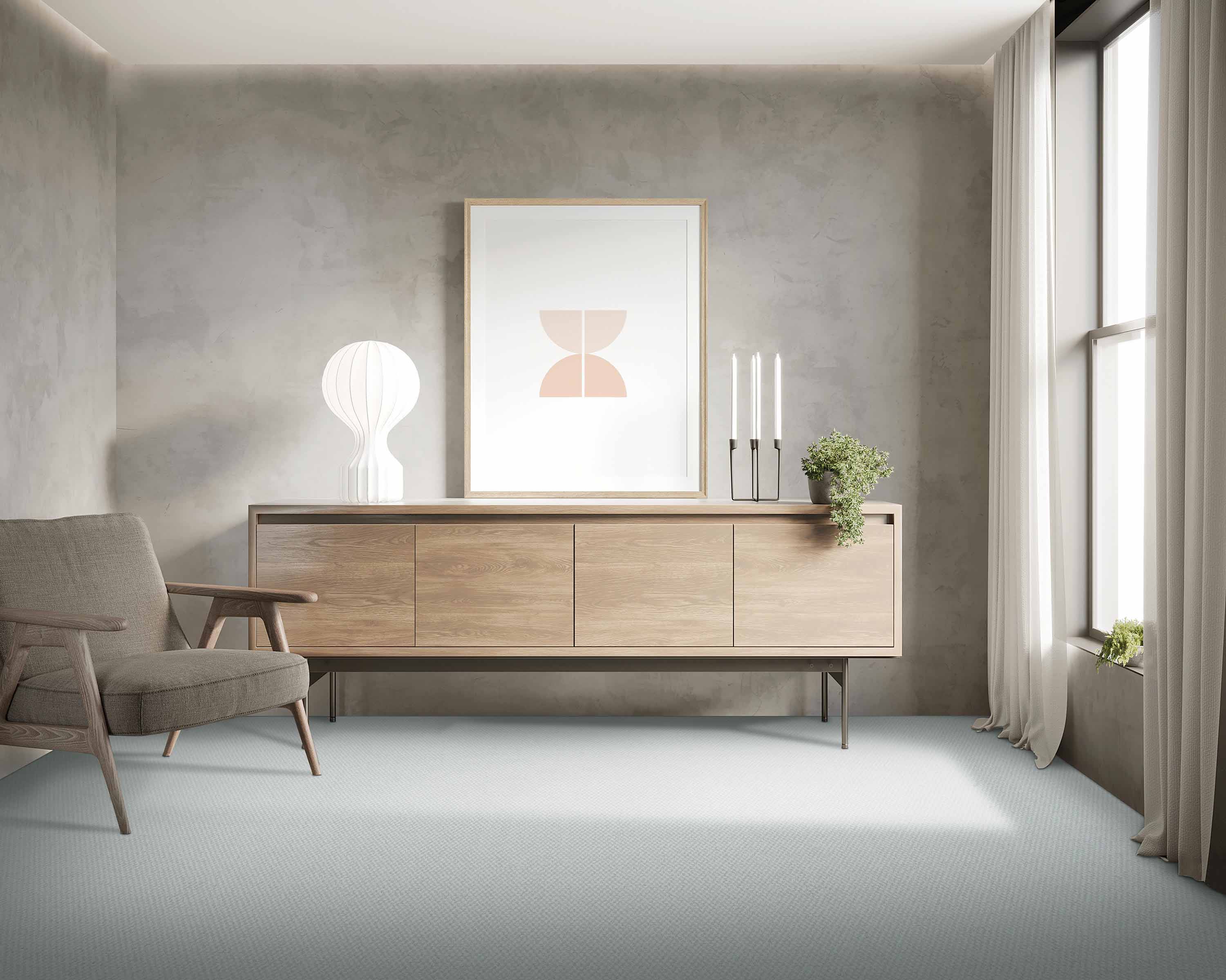 Minimalist living room with a wooden sideboard, framed art, and a chair by a window