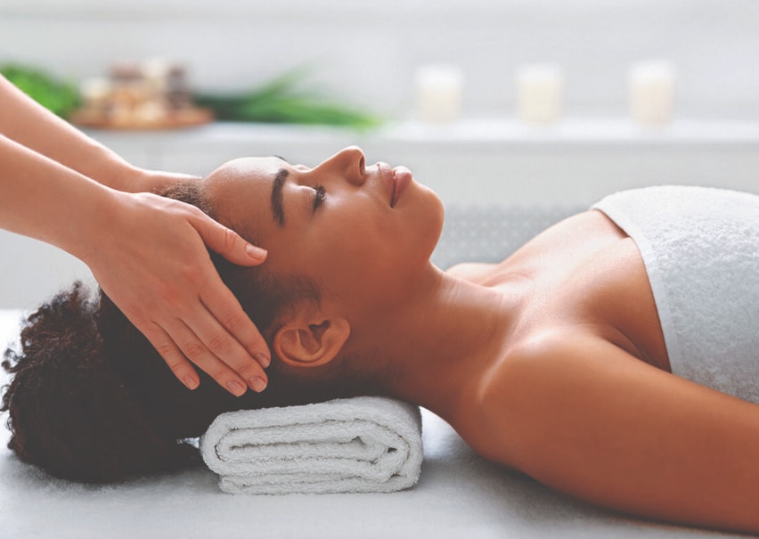 Person relaxing with a massage at a spa.
