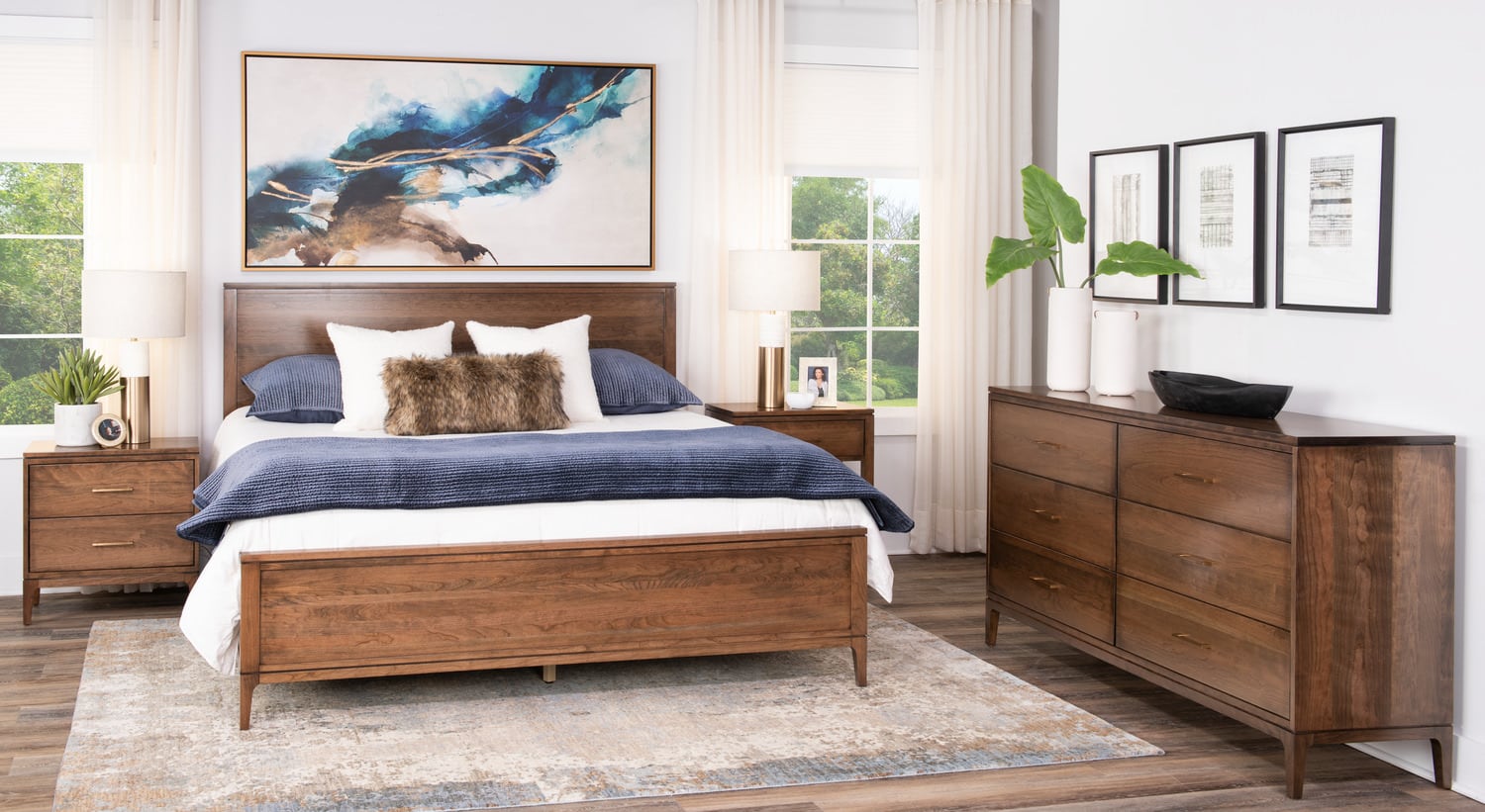 Modern bedroom with wooden bed, dresser, abstract art, and area rug