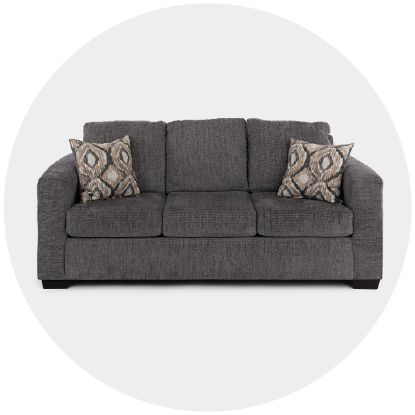 Gray sofa with two patterned pillows on a white background