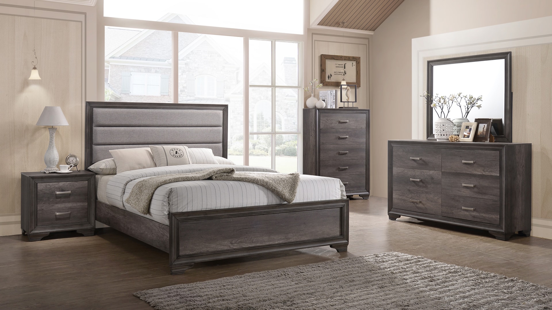 Modern bedroom with a gray bed, matching furniture, and large windows
