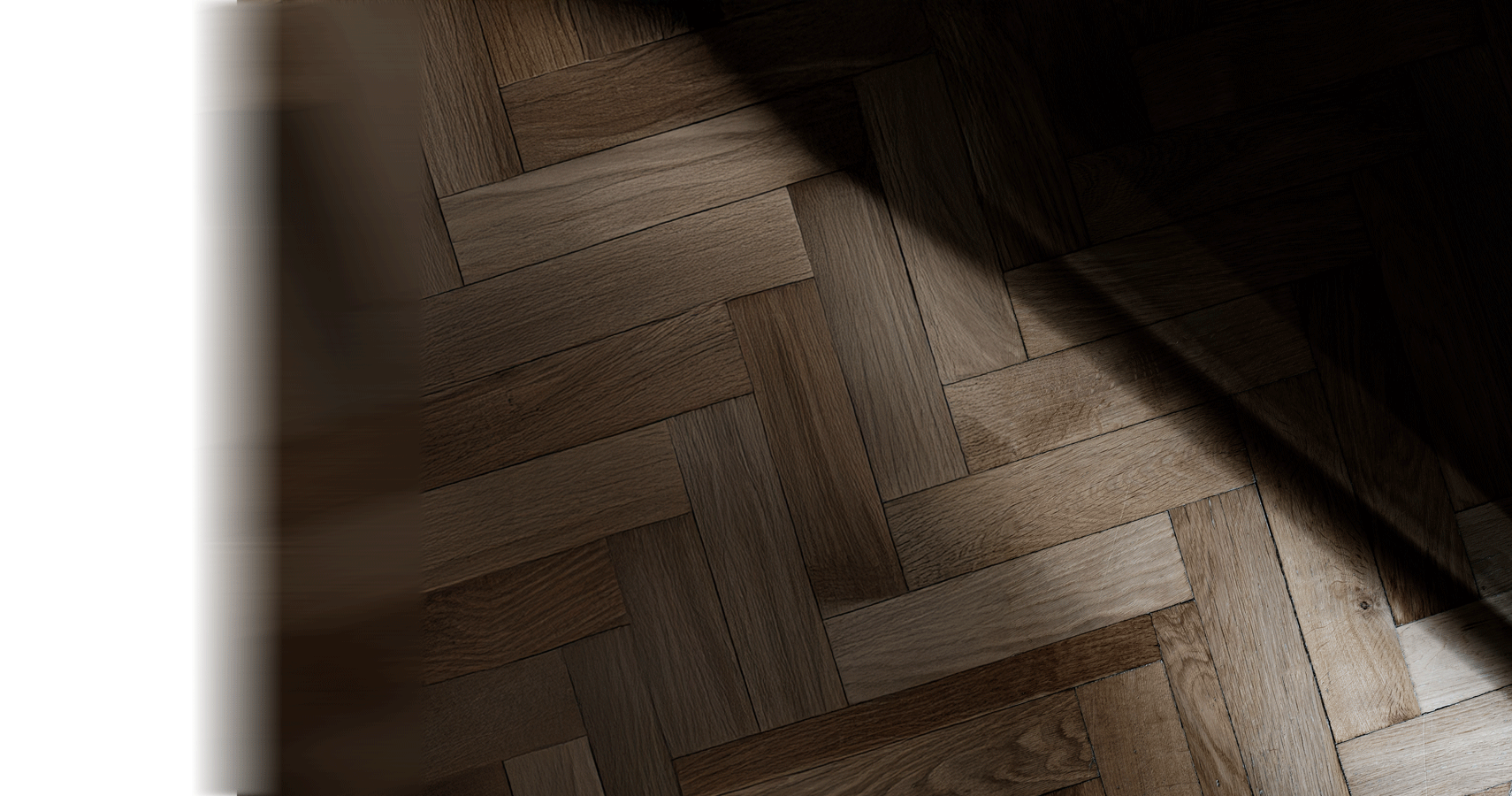Parquet flooring partly obscured by a dark shadow