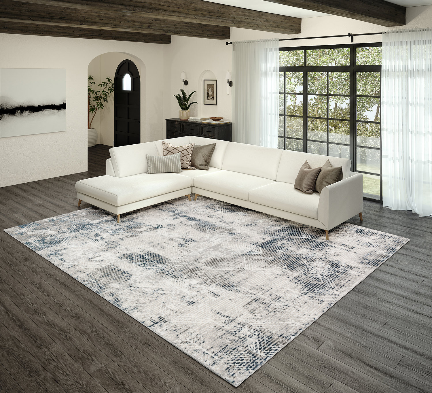 Modern living room with a sectional white sofa and a large patterned rug on a wooden floor