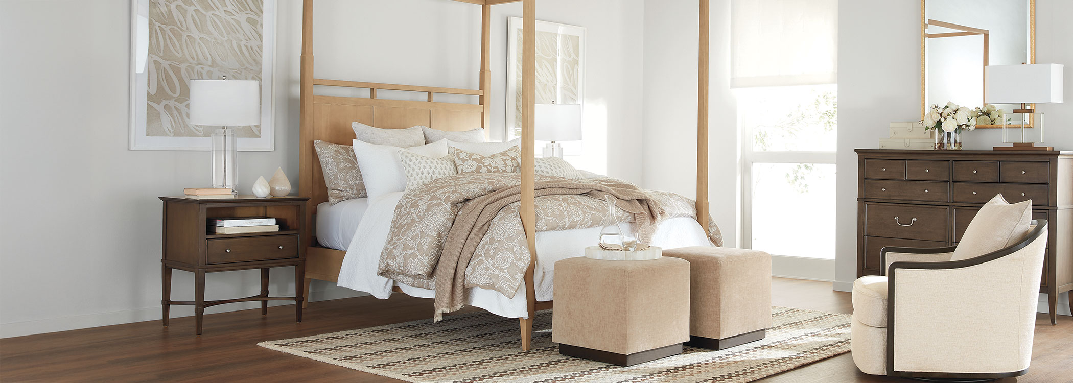 Elegant modern bedroom with a four-poster bed, white linens, and minimalist furniture