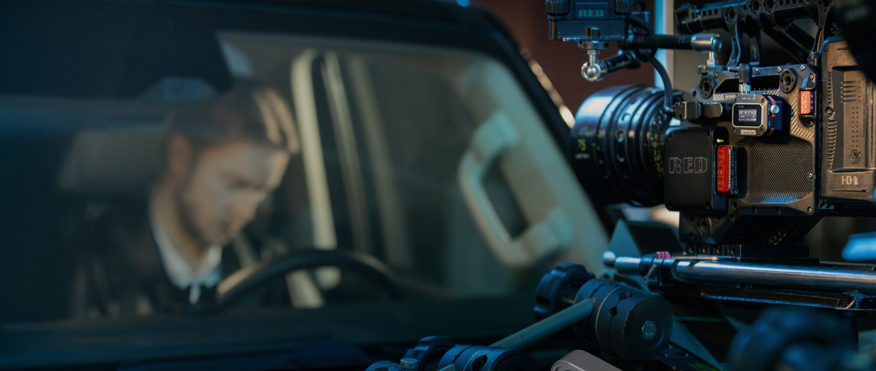 Camera filming an actor inside a car at night