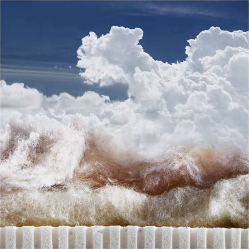 Dramatic wave mimicking fluffy clouds against a blue sky