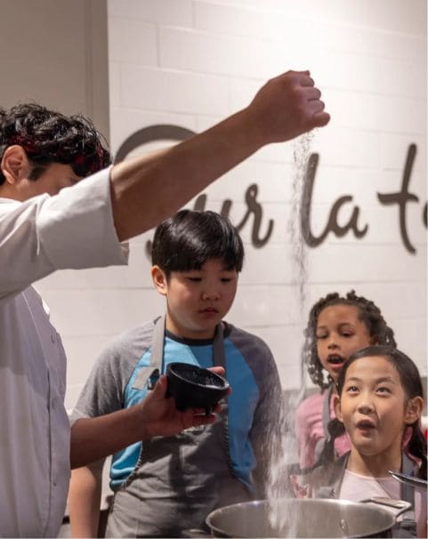 Sur La Table chef teaching kids in cooking class