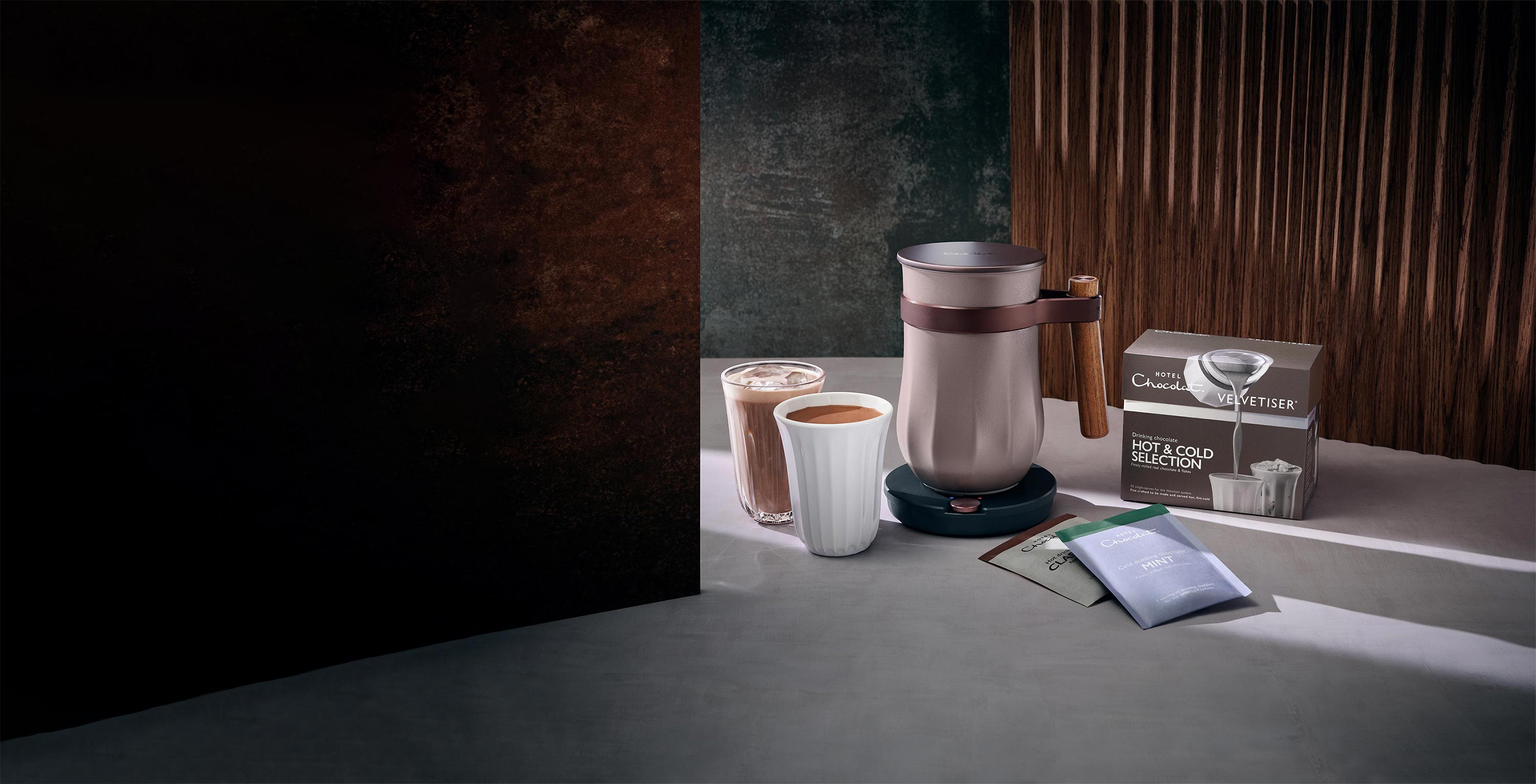 Modern coffee station with a coffee maker, mug, notebook, and smartphone on a minimalist kitchen counter