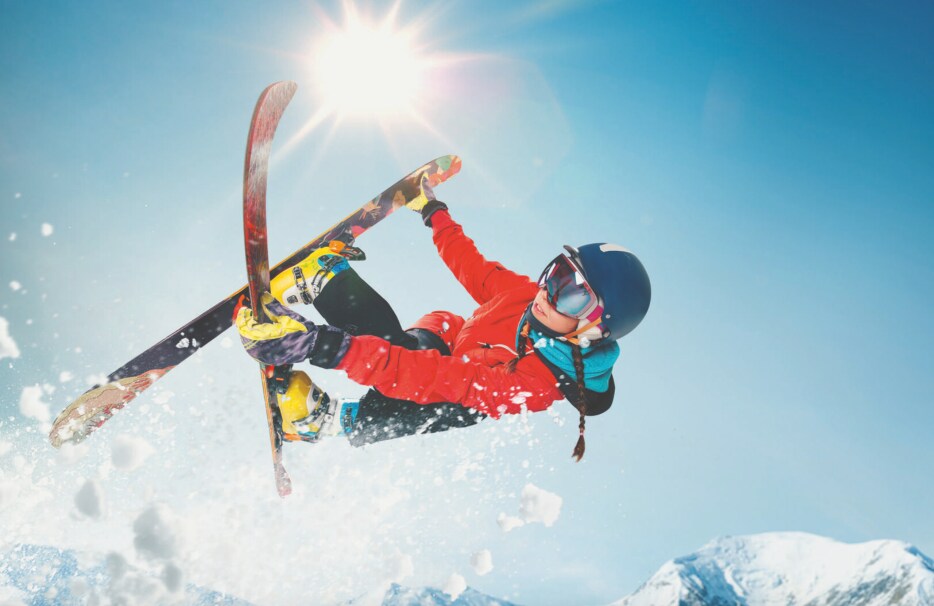 Person skiing downhill on a sunny day.