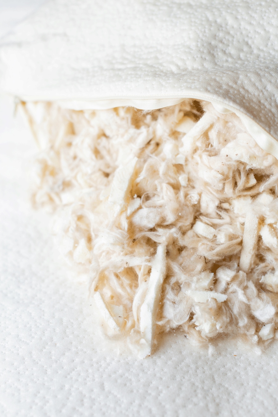 Close-up of shredded chicken wrapped in a white cloth