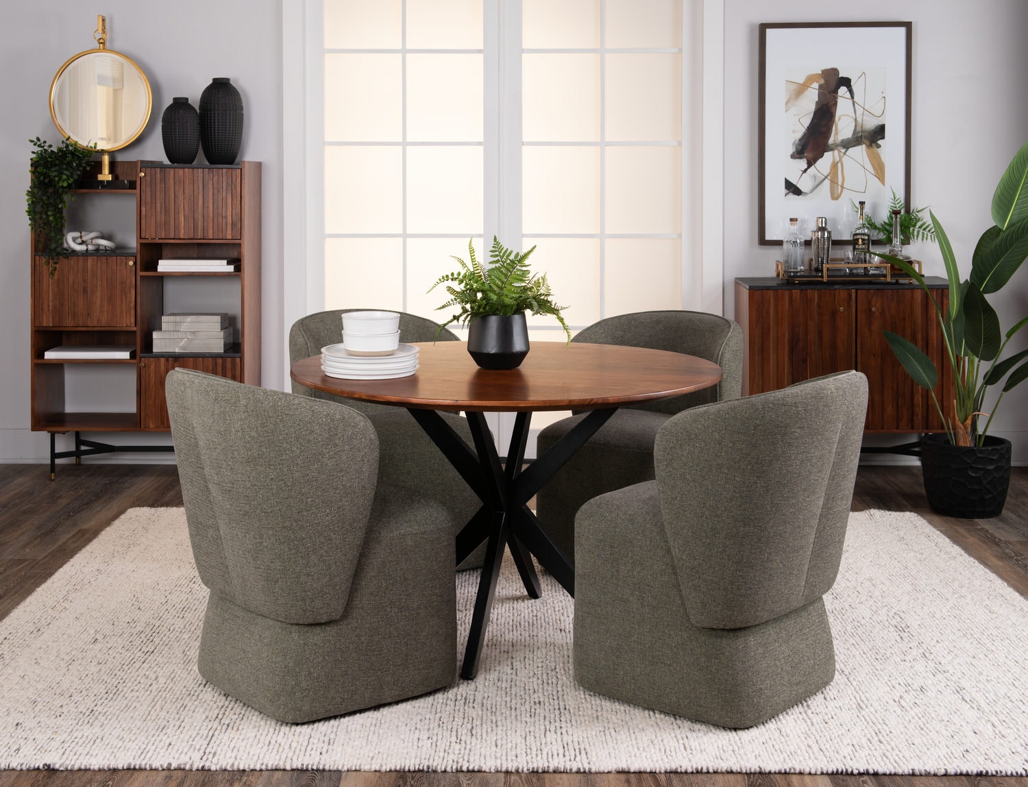 Modern dining room with round table, two grey chairs, and contemporary decor