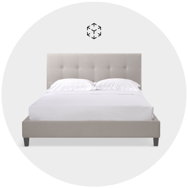 Modern grey upholstered bed with white bedding