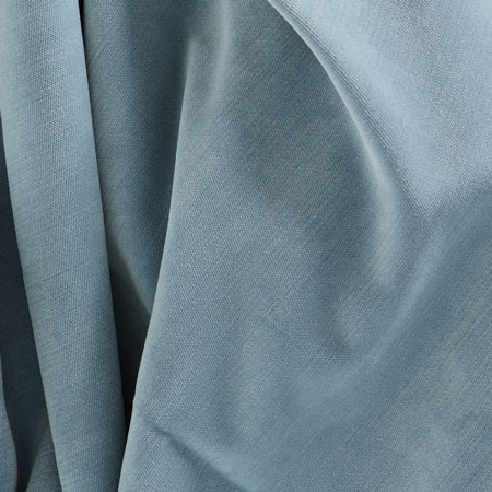 Close-up of a draped light blue fabric with soft folds