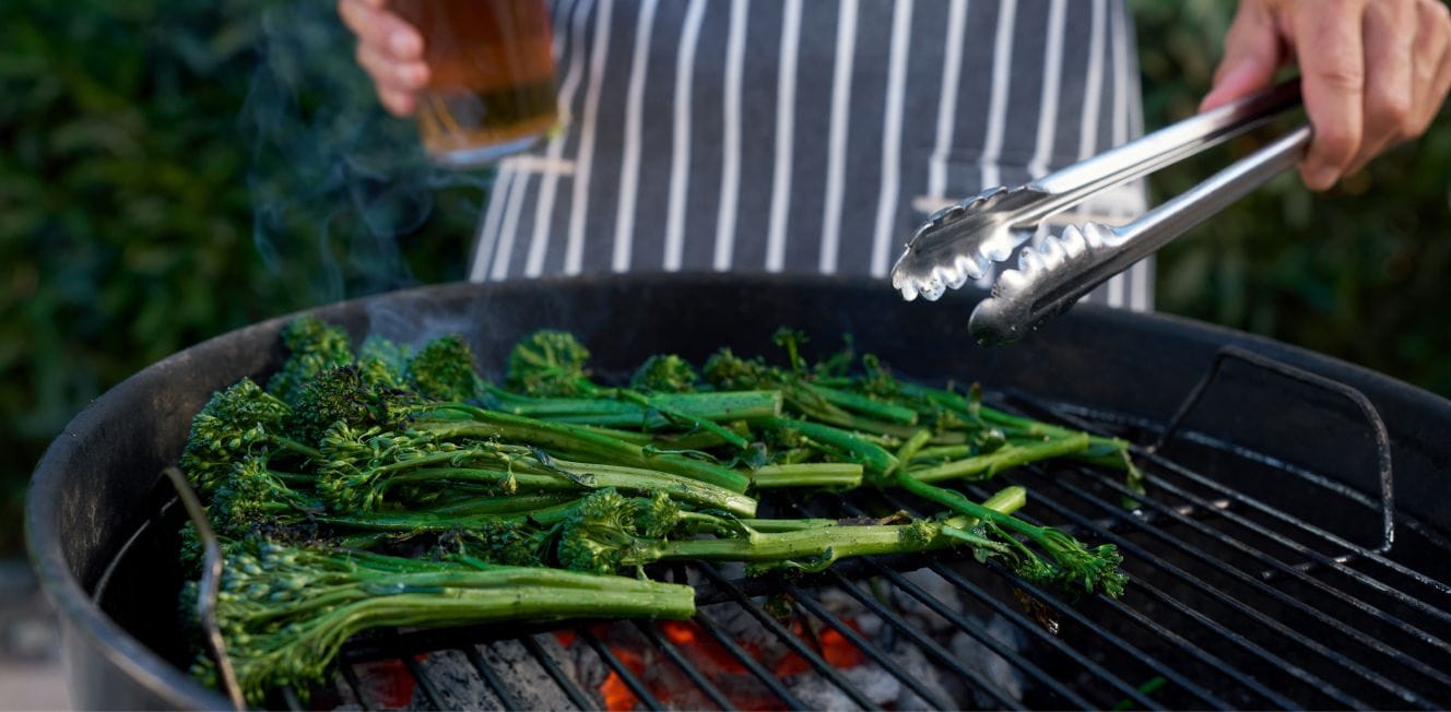 fresh broccolini being grilled on charcoal grill
